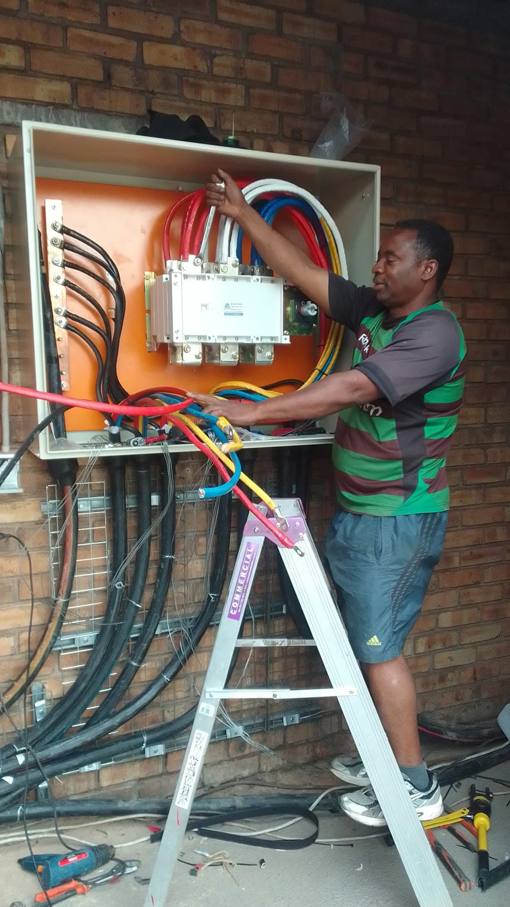 Erga electrician working on a distribution board